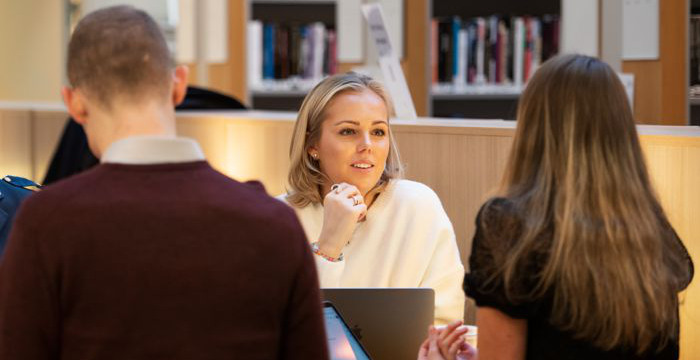 Three students in the library.