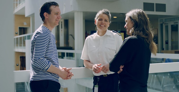 Civilian students and Officerstudent talking on the campus.
