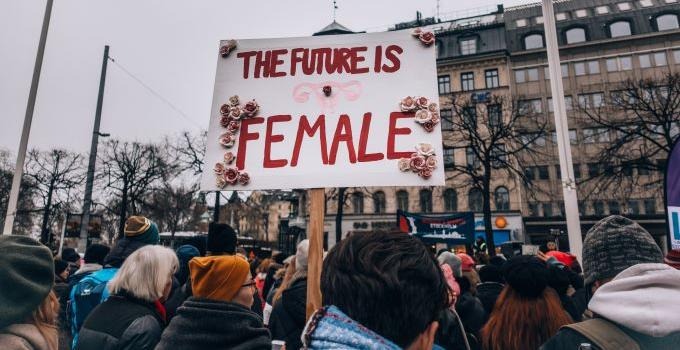 Demonstration where women hold signs with the text "the future is female". 