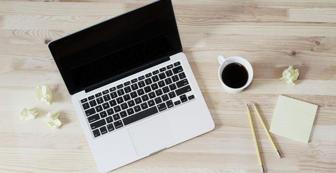 Laptop and coffe on a table.