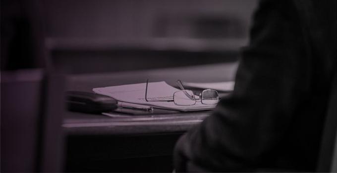 Eyeglasses on notebook on a table.