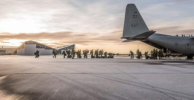 Militärer och flygplan på en flygplats 